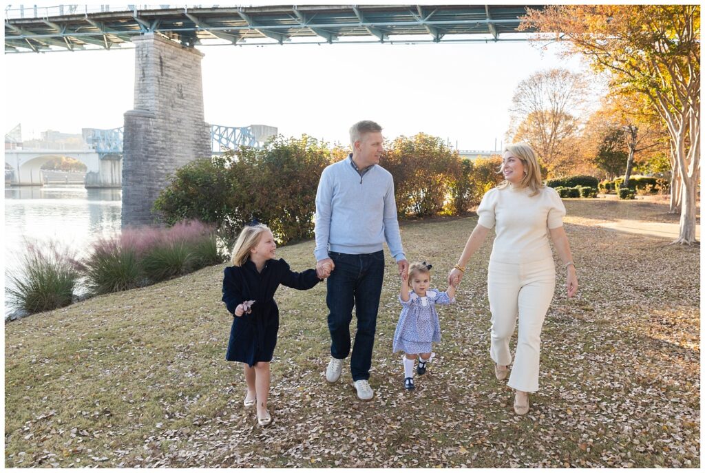 family walking together at Coolidge Park with for fall portraits with Chattanooga photographer