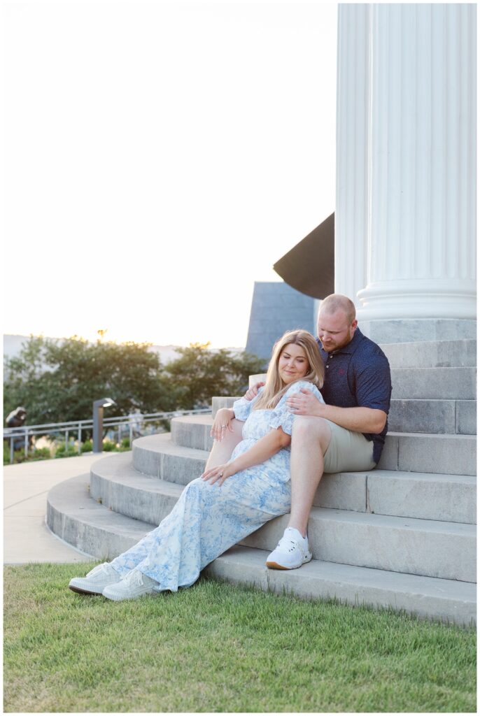 engaged couple sitting on the steps of the Hunter Museum with Chattanooga proposal photographer