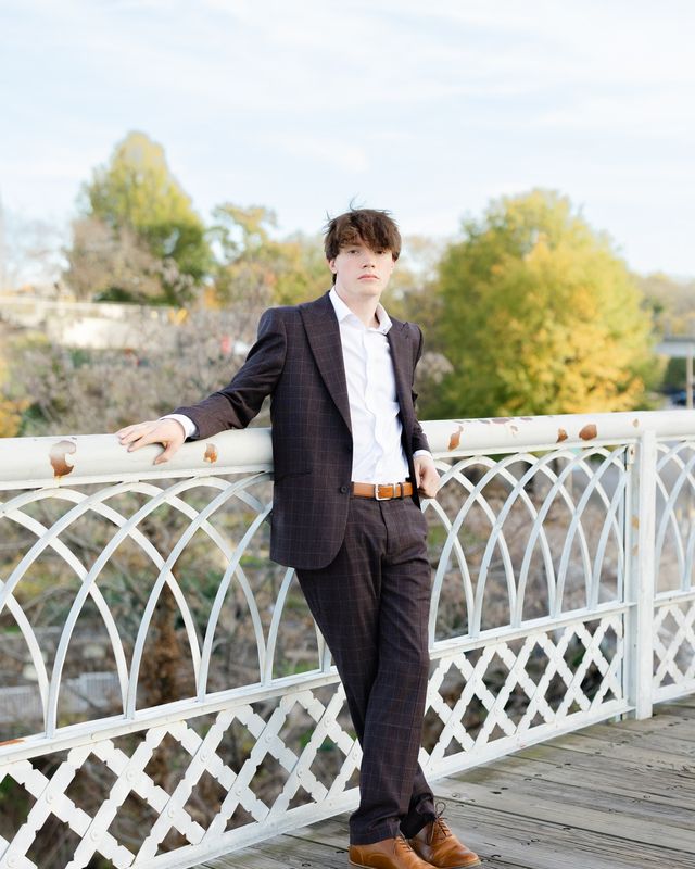 Chattanooga senior leaning against the railing of the Walnut Street Bridge