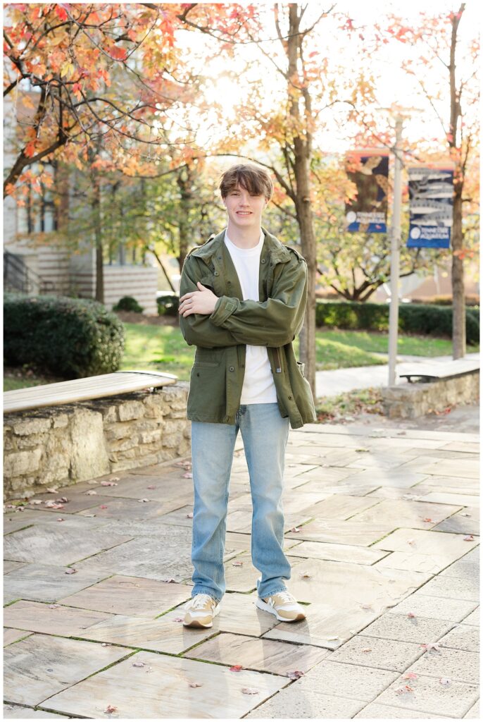 senior guy posing in front of orange and red trees for Chattanooga portrait session