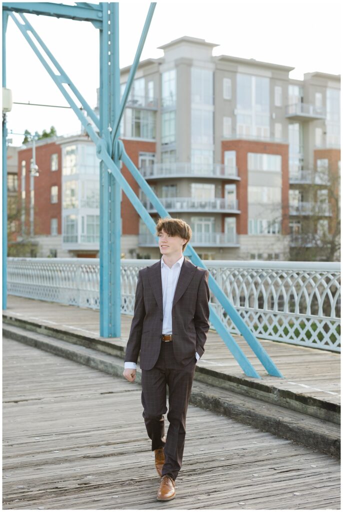 senior guy walking with a hand in his pocket on the Walnut Street Bridge