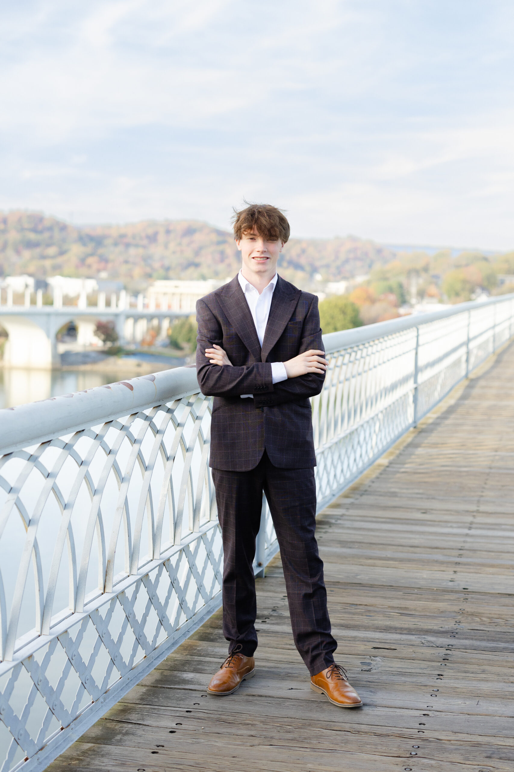 high school senior posing against the railing on the Walnut Street Bridge