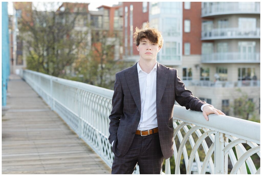 senior guy wearing a blue striped suit and posing on the Walnut Street Bridge