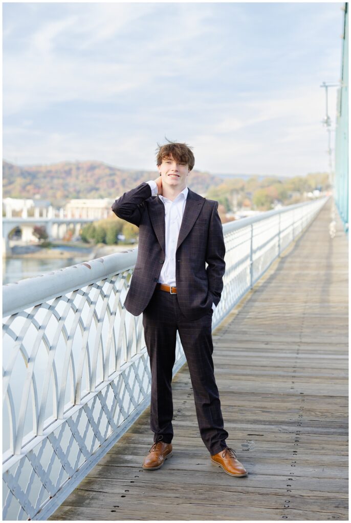 guy posing with his arm on his neck and standing on the Walnut Street Bridge