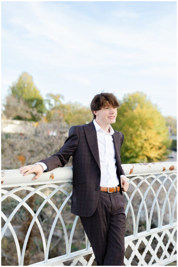 senior guy leaning against the white railing on the Walnut Street Bridge