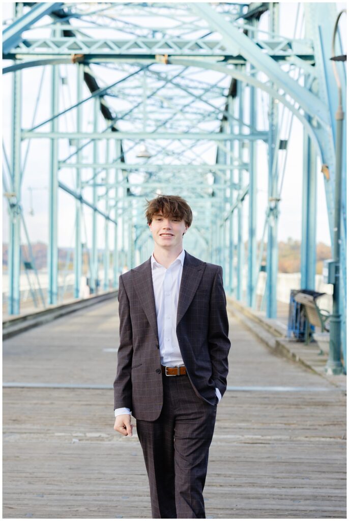 Chattanooga senior photographer walking with Owen on the bridge