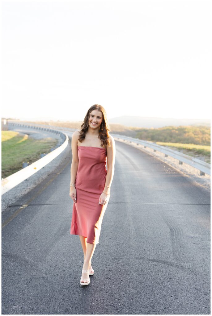senior girl walking along the road and laughing for Raccoon Mountain session