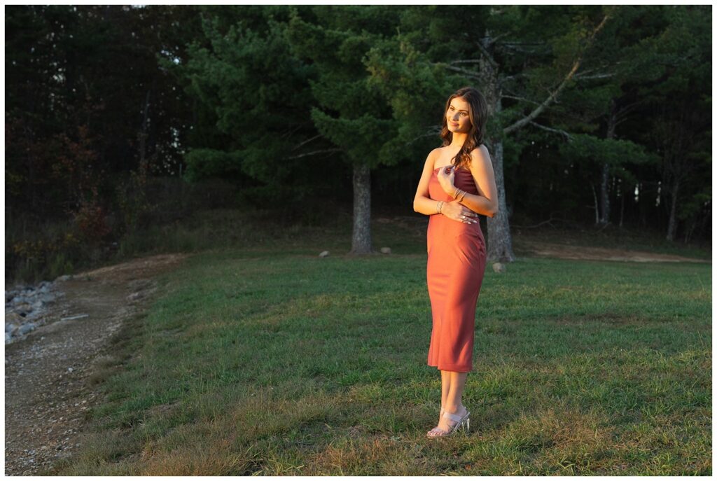 senior girl facing the sun and holding her hair at Raccoon Mountain portrait session