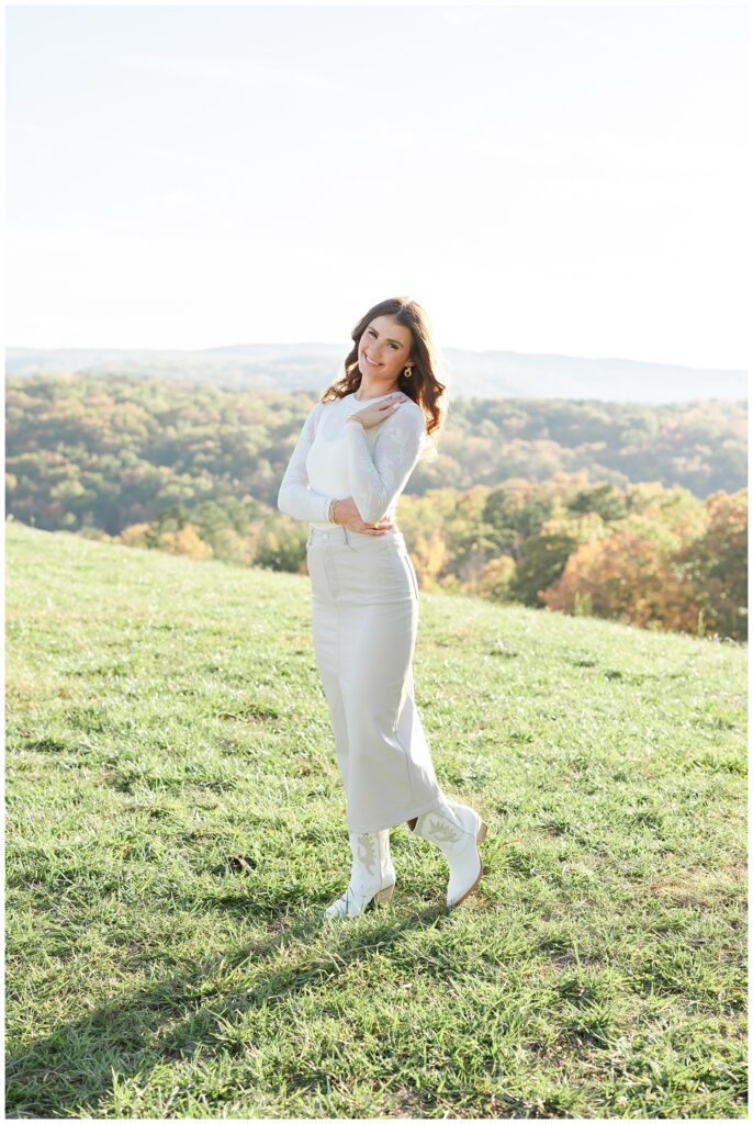 senior girl posing with her hand on her waist and shoulder for Racoon Mountain session