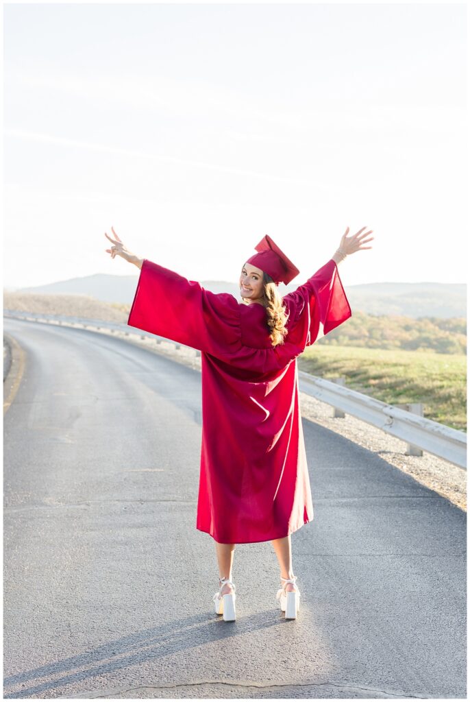 senior holding her hands in the air showing a two and five for her graduation year