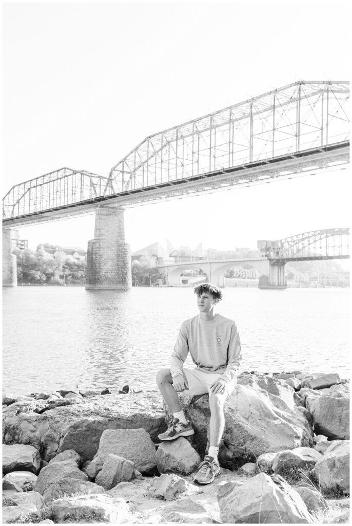 senior guy posing on the rocks at Renaissance Park in downtown Chattanooga 