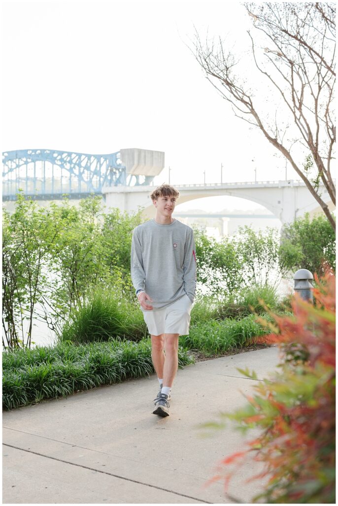senior guy walking on the sidewalk at Renaissance Park in downtown Chattanooga 