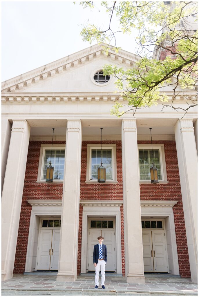 senior boy posing in front of the tall columns of the McCallie School chapel in Chattanooga