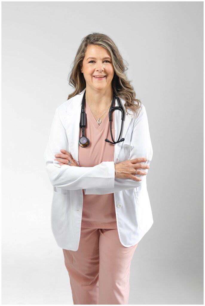 nurse wearing a white coat and wearing stethoscope and posing for branding session by Chattanooga photographer