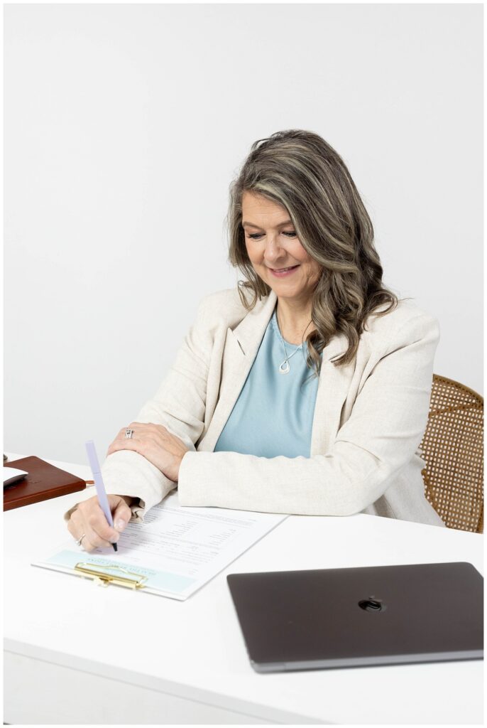 Chattanooga branding session photographer with nurse working on her clipboard at a white desk