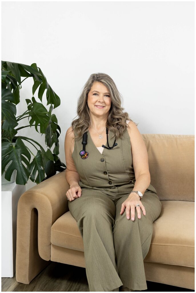 Chattanooga branding session with nurse in a green jumpsuit sitting on a brown couch
