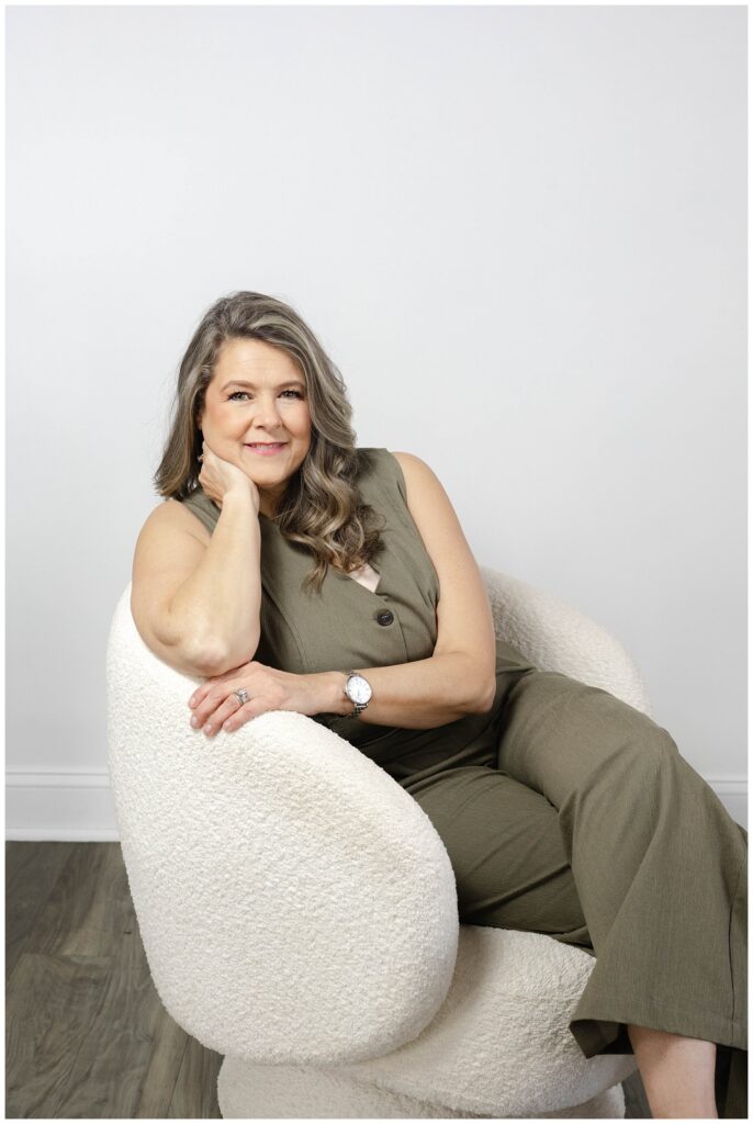 branding session with nurse practitioner posing in a white chair with Chattanooga studio photographer