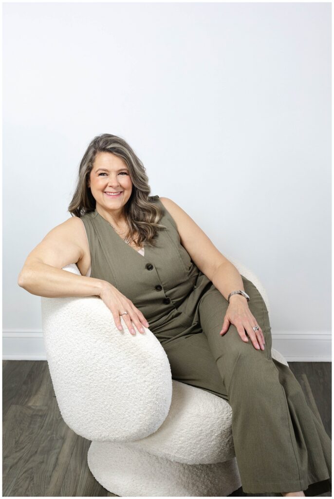 branding session in Chattanooga with nurse practitioner posing in a white chair with studio photographer