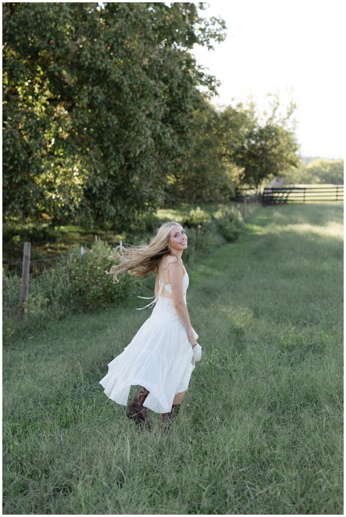 Chattanooga senior photographer on client's family farm for graduation photoshoot in the fall