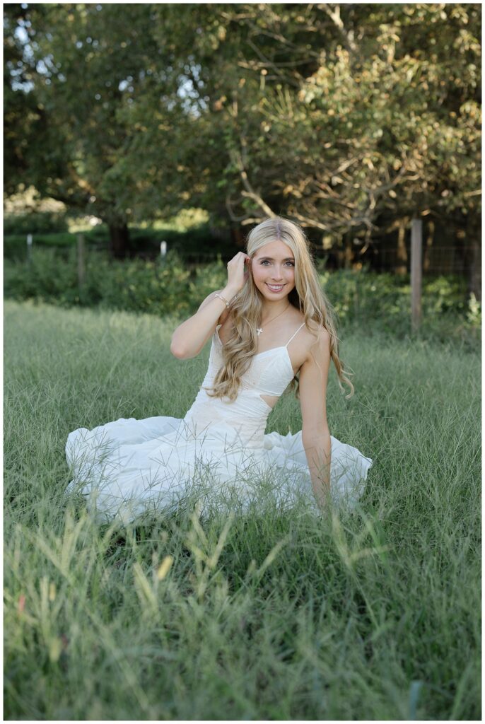 north Georgia senior sitting in a tall field for session with Chattanooga senior photographer