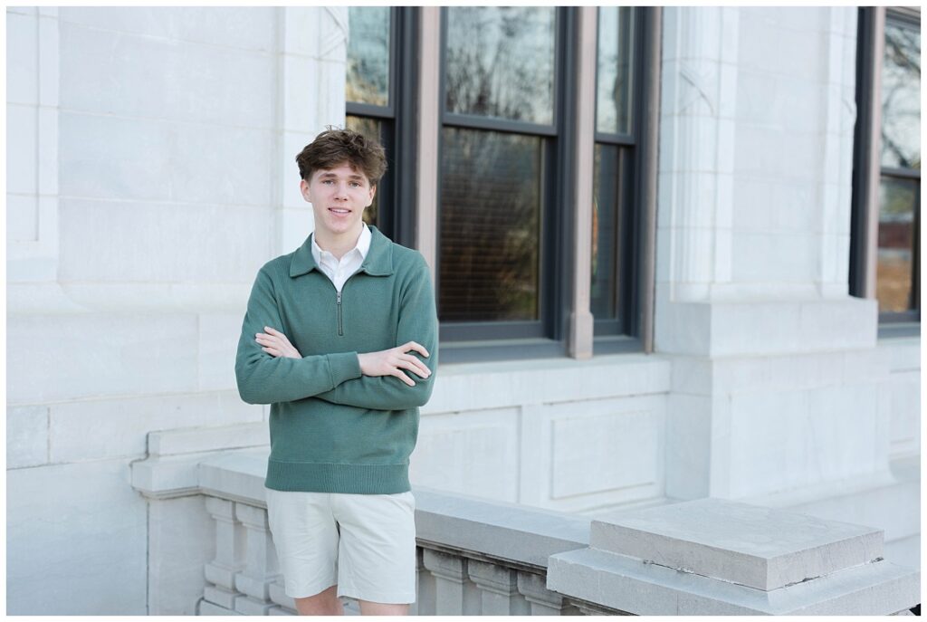 high school senior posing on the top of the stairs at the Chattanooga courthouse downtown