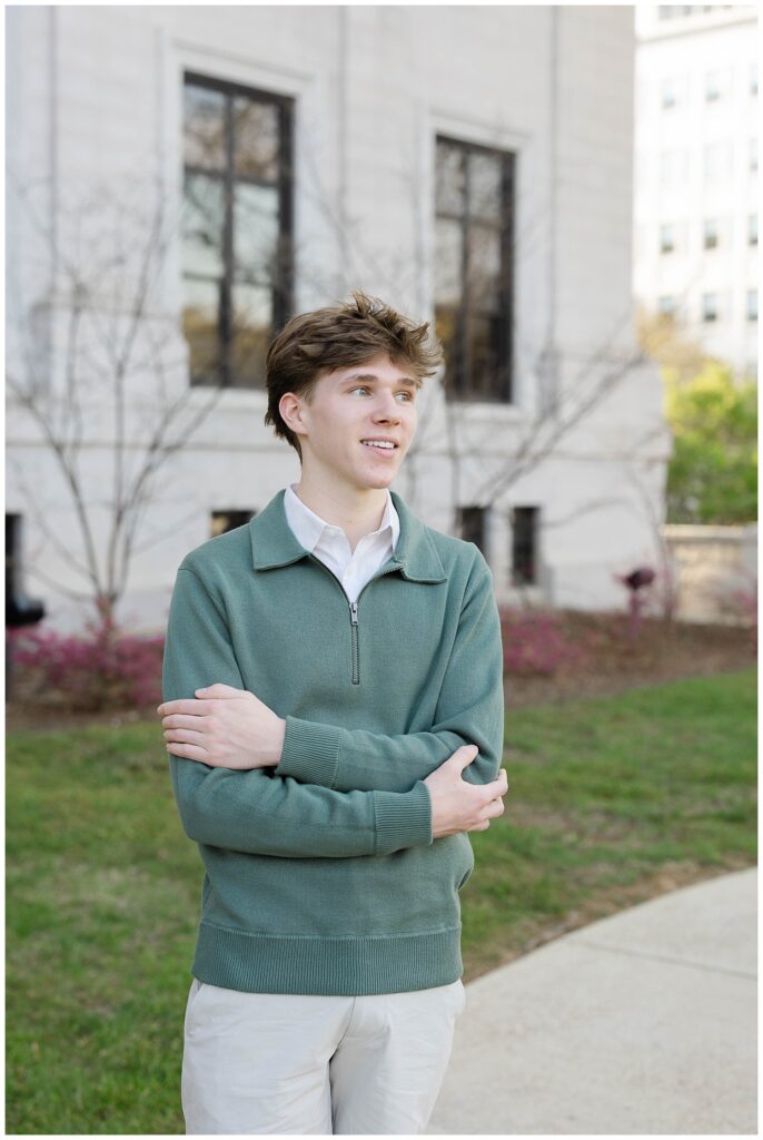 senior guy crossing his arms while posing on the sidewalk around the downtown courthouse in Chattanooga 