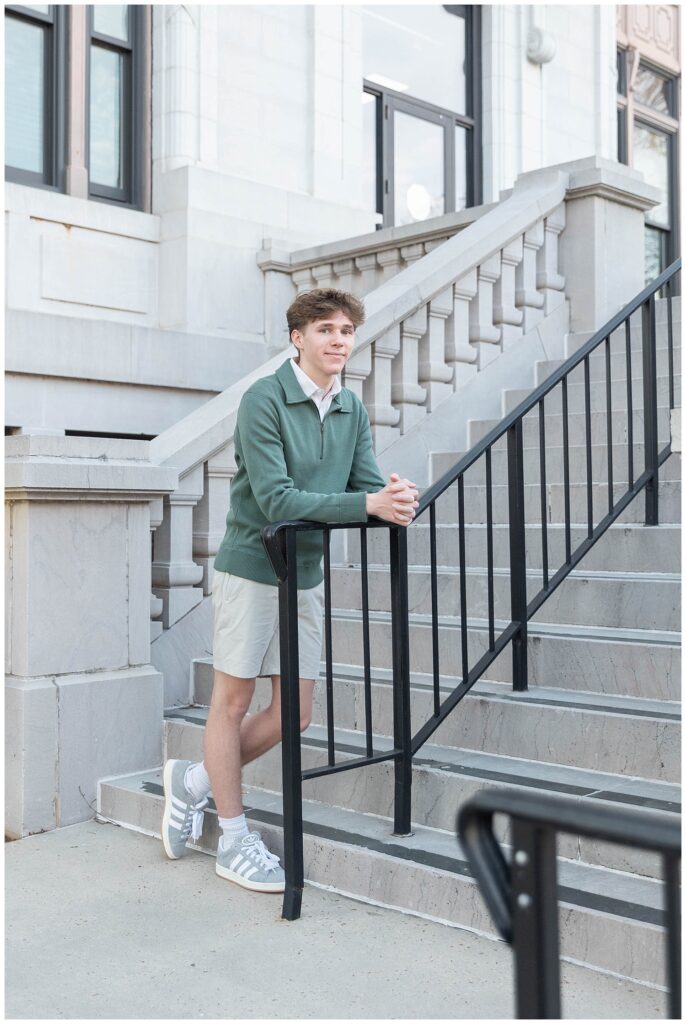 senior guy leaning forward on the black stairwell at the Chattanooga courthouse