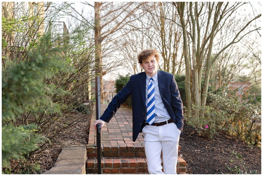 high school senior crossing his ankles and leaning against a handrail at McCallie School in Chattanooga
