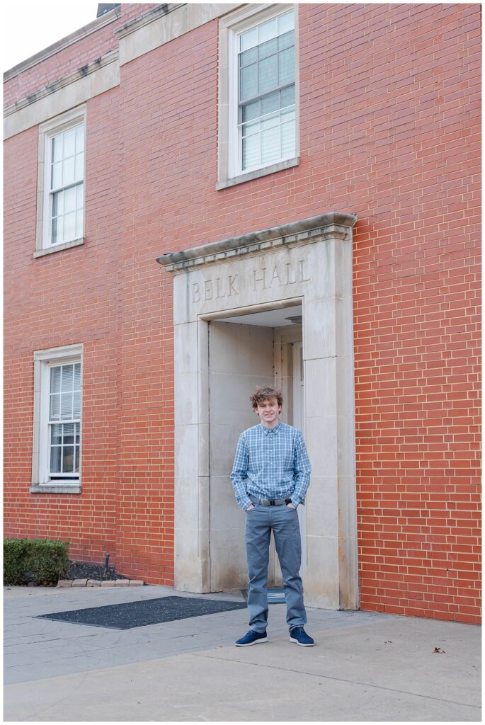 McCallie School high school senior posing in front of his form on campus for spring portraits