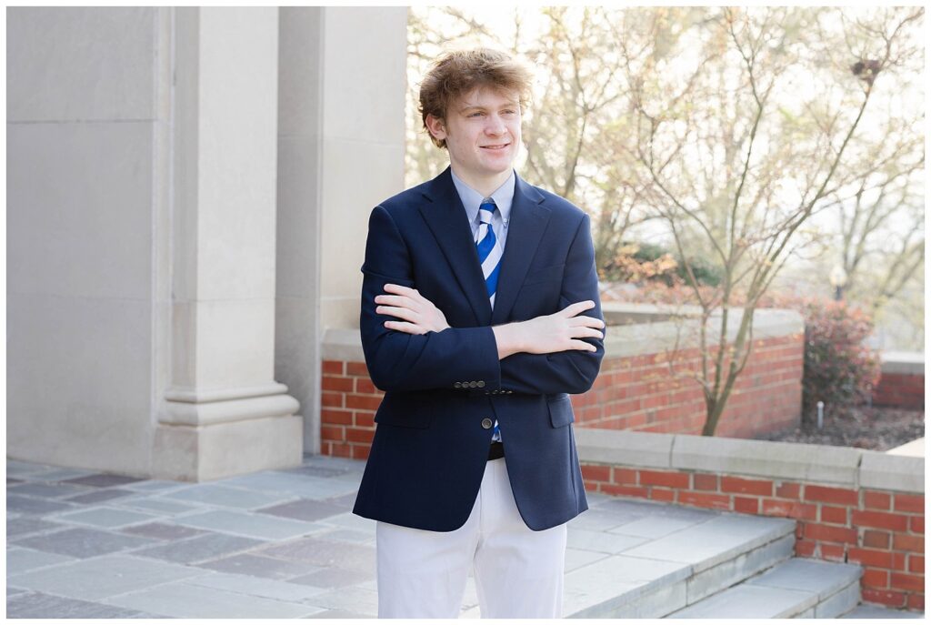 senior crossing his arms on the steps of the chapel at McCallie School in Chattanooga