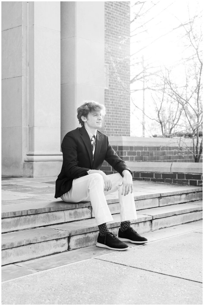 McCallie School senior posing on the steps in front of the chapel for spring session