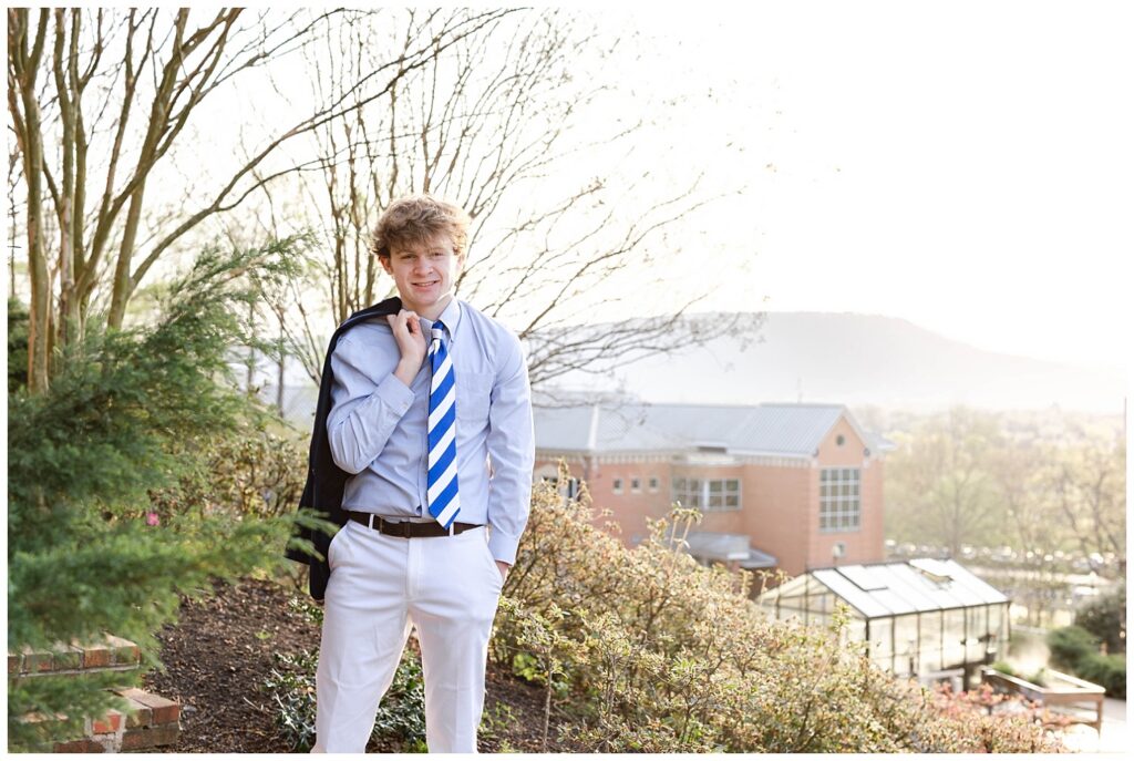 senior posing on McCallie School's campus for spring session with Lookout Mountain in the background